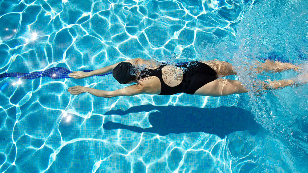 Women swimming a pool