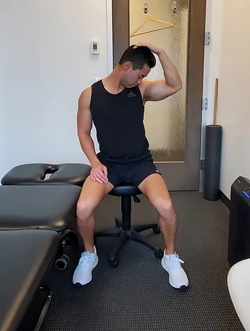 Physiotherapist Eric Lau demonstrating a levator scapulae stretch.