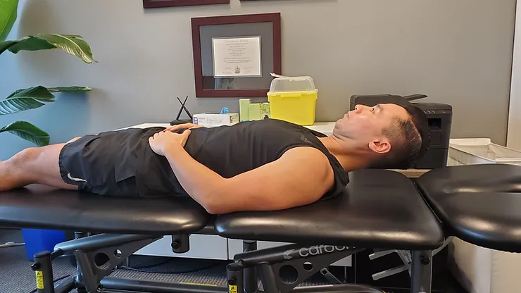 Physiotherapist Eric Lau demonstrating a deep neck flexor activation exercise.