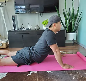 Physiotherapist Eric Lau demonstrating a prone back extension exercise.