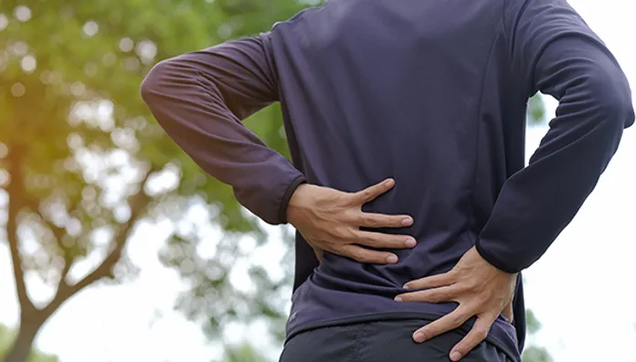 Man suffering from back pain due to a lower back herniated disc