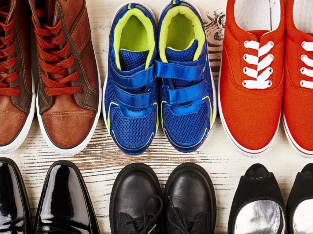 Many different types and colors of men's shoes on the floor