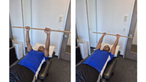 Physiotherapist Najih Ismail preforming a cane assisted shoulder flexion exercise.