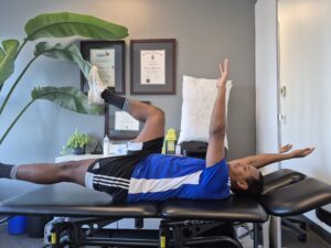 Physiotherapist Najih Ismail demonstrating a bird dog exercise.