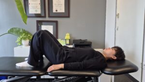 Physiotherapist Gahoi Kim demonstrating a bridge exercise
