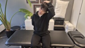 Physiotherapist Gahoi Kim preforming the upper trapezius stretch
