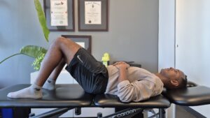 Physiotherapist Najih Ismail demonstrating a bridge exercise.