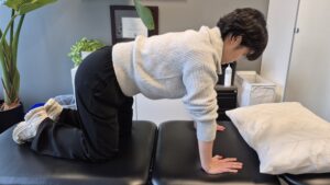 Physiotherapist Gahoi Kim performing a four point kneel exercise