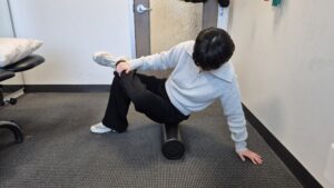 Physiotherapist Gahoi Kim demonstrating how to foam roll the piriformis muscle