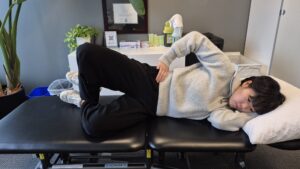 Physiotherapist Gahoi Kim demonstrating the clam shell exercise