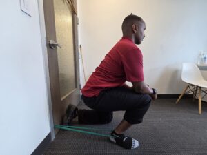 Physiotherapist Najih Ismail practicing an exercise to promote posterior glide of the talus bone