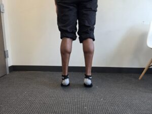 Physiotherapist Najih Ismail demonstrating a heel raise exercise